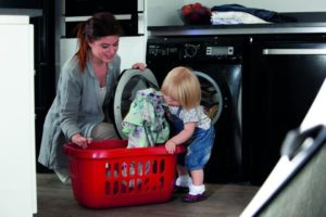 woman doing laundry with daughter